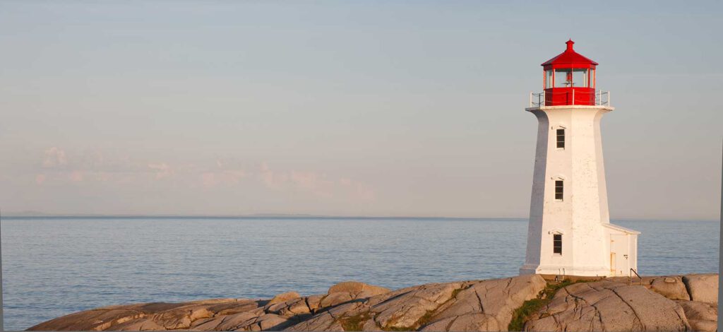 a lighthouse, on a rock next to the sea