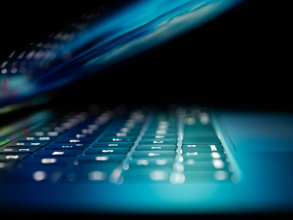 closeup photo of turned-on blue and white laptop computer